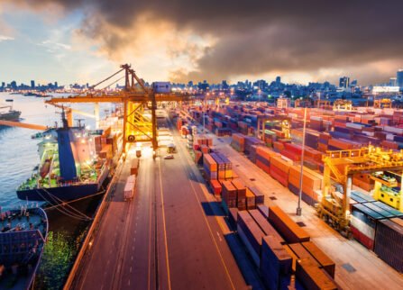 Logistics and transportation of Container Cargo ship and Cargo working crane bridge in shipyard