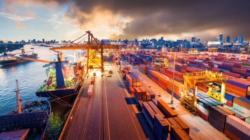 Logistics and transportation of Container Cargo ship and Cargo working crane bridge in shipyard